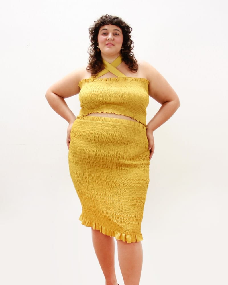 Front of a model wearing a size L Cinch Me Smocked Skirt in SUNFLOWER by Lovefool. | dia_product_style_image_id:264903